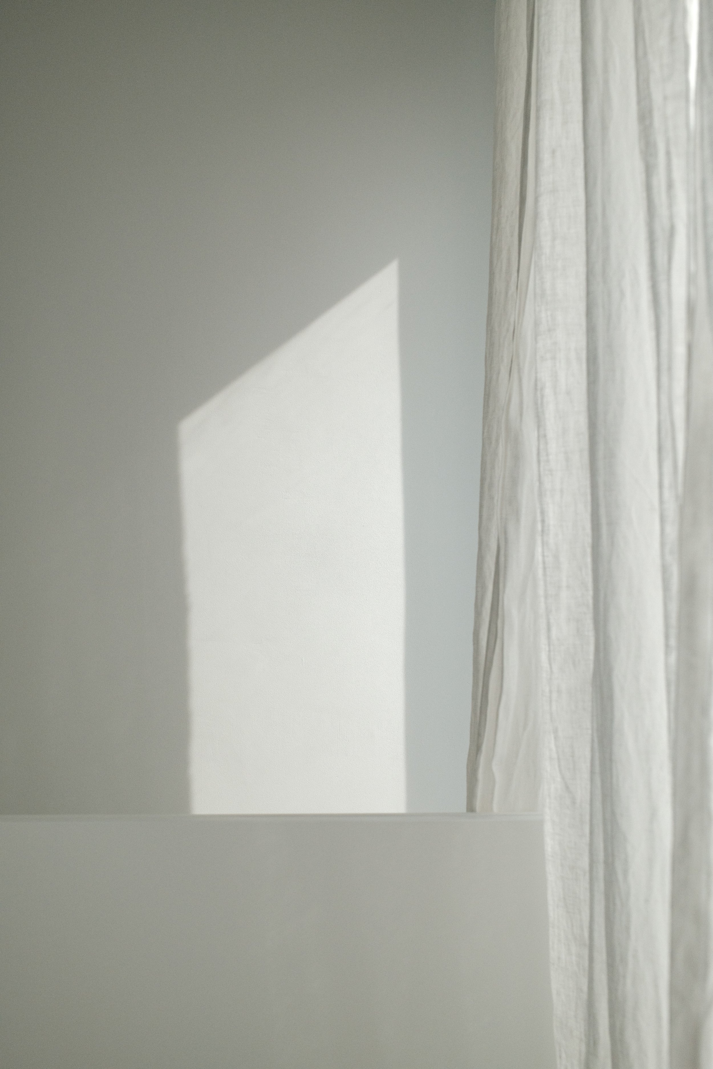 Soft daylight across a pale wall